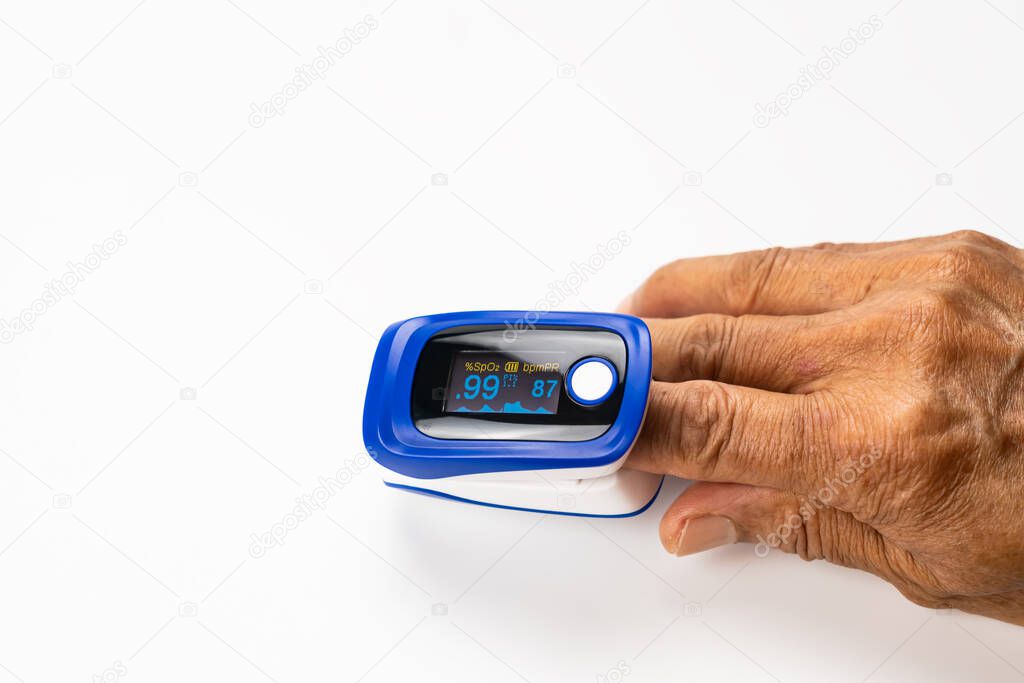 High angle view of doctor using pulse oximeter measured blood value of pulse rate and value of oxygen saturation at the finger tip of senior patient on white background with clipping path.