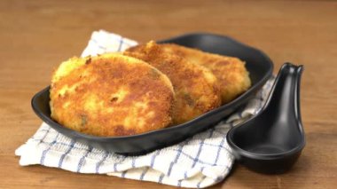 Ketçapı siyah bardağa döküyorum. Yeni hazırlanmış jambonlu peynirli kroket. Siyah tabakta..