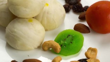 Fasulyeli pasta ya da Çin hamur işi, tatlı mung fasulyesi ezmesi ve tuzlu yumurta sarısı, kivi, kuru üzüm, domates ve beyaz arka planda kaju fıstığı..