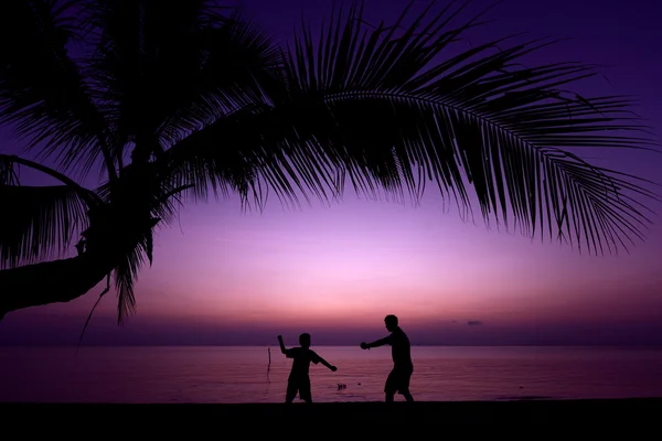 Father and son exercising on beach — Stock Photo, Image