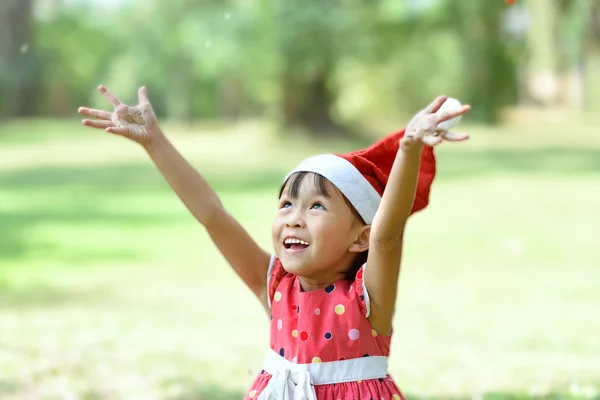 Gelukkig meisje in Kerstman hoed — Stockfoto