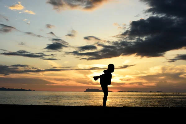 Silhouette of boy doing martial art — Stock Photo, Image