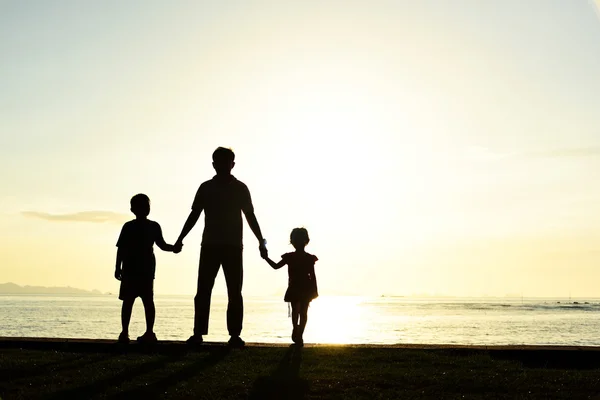 Silhouette of family on beach — Stock Photo, Image