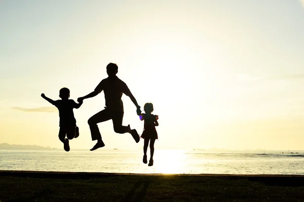Silhouette of family on beach — Stock Photo, Image