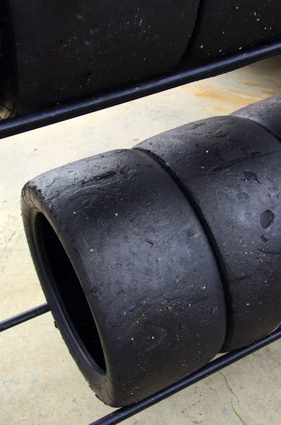 Rows of worn out slick tires — Stock Photo, Image