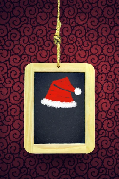 Hanged Slate with Christmas cap — Stock Photo, Image