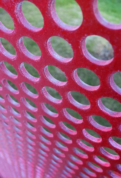 Перфорированная красная панель — стоковое фото