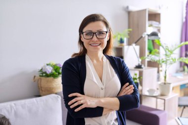 Kolları bağlı, kendinden emin, olgun bir kadının portresi.