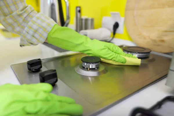 Close-up of womans hand washing hob of gas stove — Stock Photo, Image