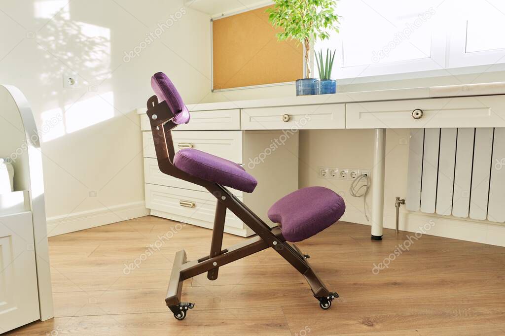 Orthopedic ergonomic kneeling chair in the interior of childrens room, home office
