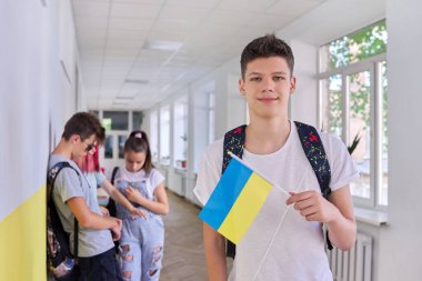 Teenager student with Ukraine flag, school corridor group of students background clipart