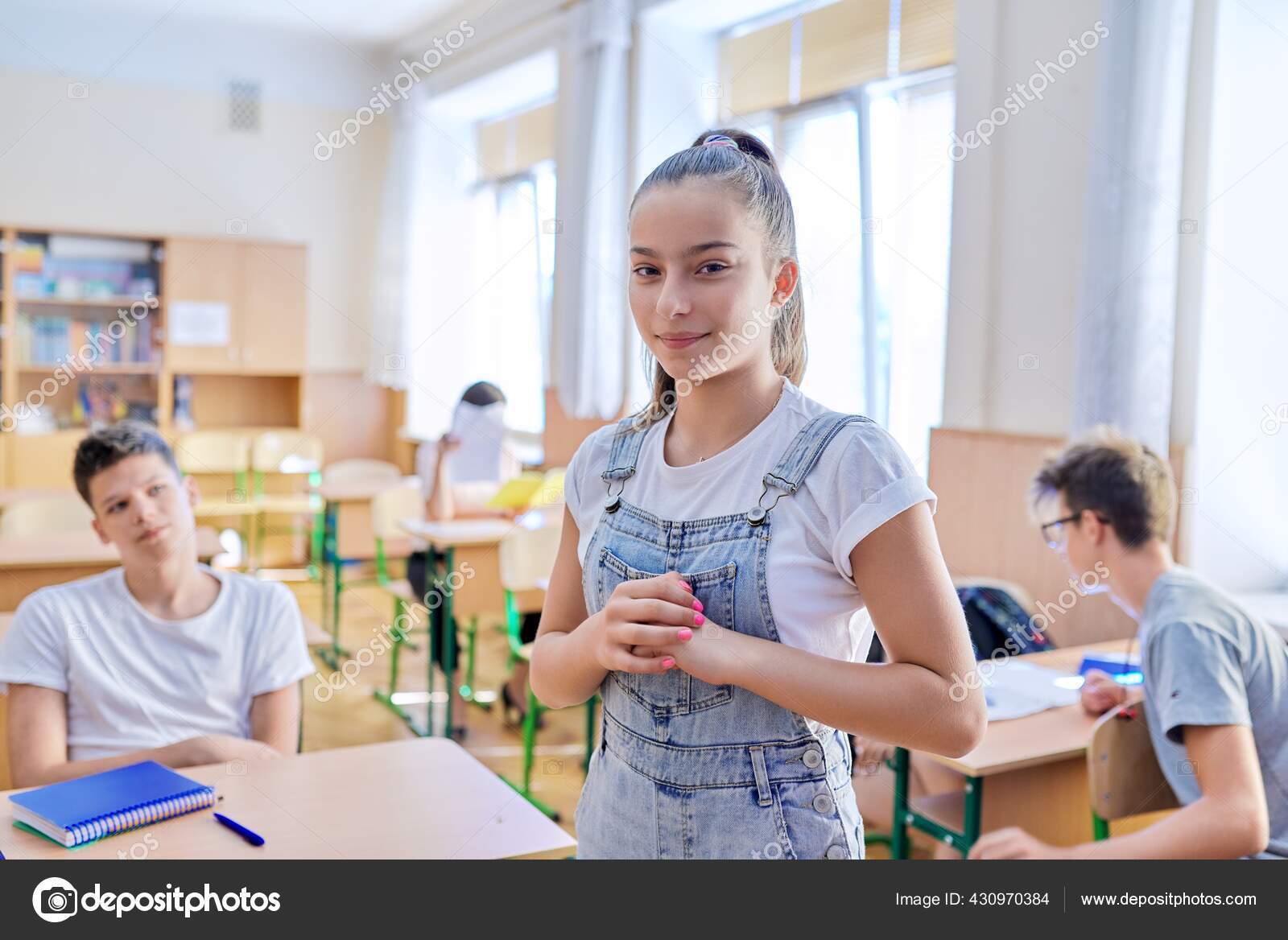 Teenage student taking exam, classroom with study students background Stock  Photo by ©Valerii_Honcharuk 430970384