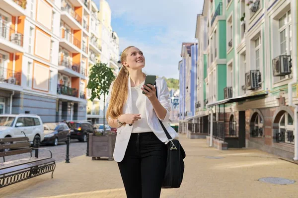 Young beautiful woman using smartphone, business woman in white jacket — Stock Photo, Image