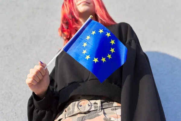 Female student teenager with EU flag in hand, gray outdoor wall background — Stock Photo, Image