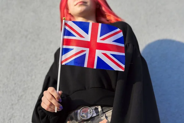 Female student teenager with British flag, gray outdoor wall background — Stock Photo, Image