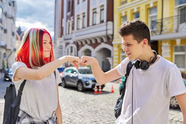 Teenage boy and girl meeting, greeting with hands — Stock Photo, Image