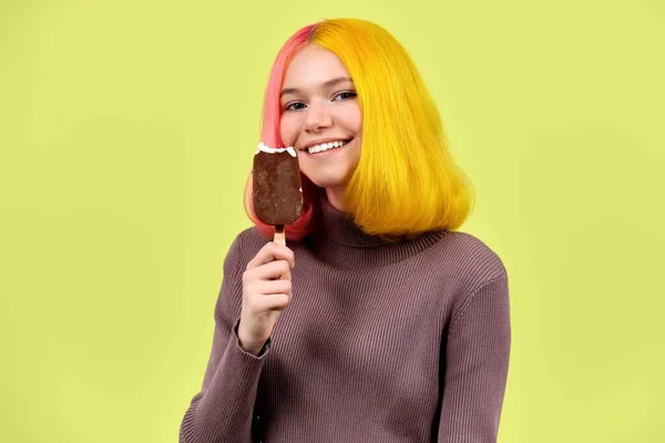 Ung vacker modell tonåring med choklad glass i handen på gul bakgrund — Stockfoto