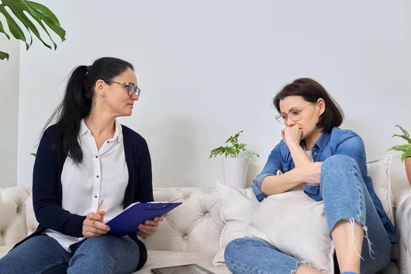 Midlife crisis, mature woman in consultation with psychologist