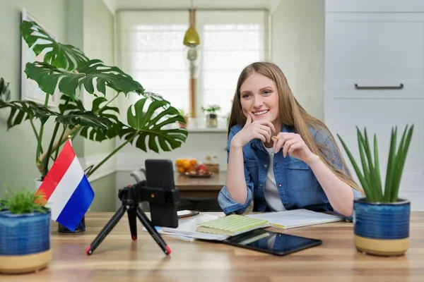 Mujer estudiante sentada en casa estudiando en línea, mirando webcam smartphone — Foto de Stock
