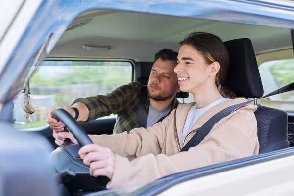 Father teaching his teenage son to drive — Stock Photo, Image