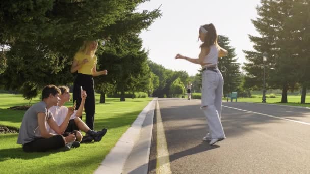 一群嬉皮士少年在路上公园里玩乐，少女在街上跳舞 — 图库视频影像