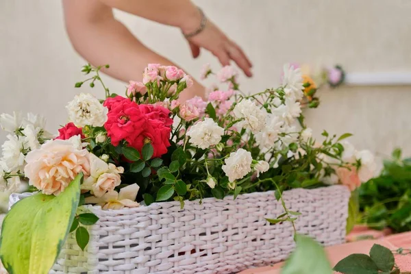 女性花屋は屋外で花の配置を行います。フラワーバスケット作成ワークフロー — ストック写真