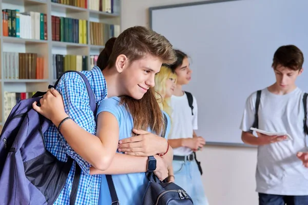 Grupo de adolescentes chicos y chicas son bienvenidos, conocer, sonreír, regocijarse dentro de la escuela —  Fotos de Stock