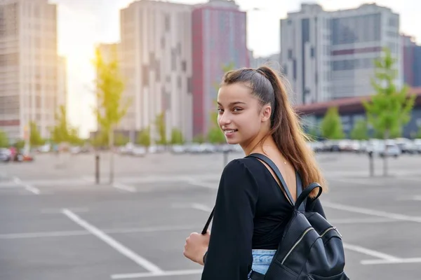 Fashionabla vackra leende tonåring flicka i shorts med ryggsäck tittar på kameran — Stockfoto