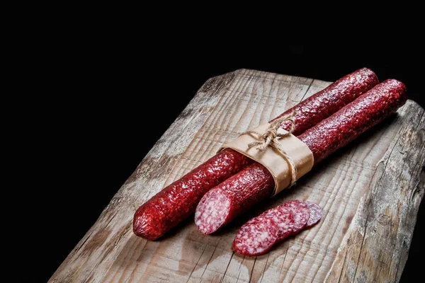 Trockenfleischwurst Auf Einem Holzteller Mit Gemüse Stockfoto