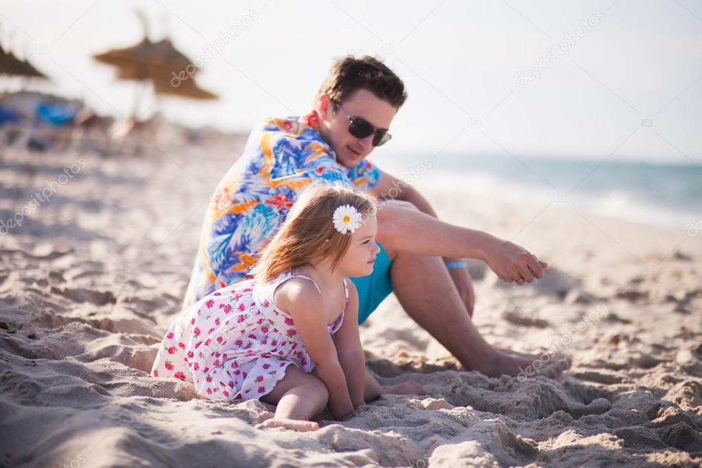 Father and daughter on the beach near the sea
