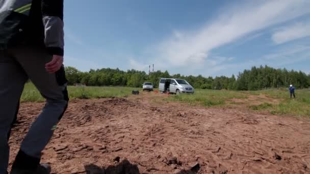 Homme en uniforme gris se promène à van sur le chantier ouvert — Video