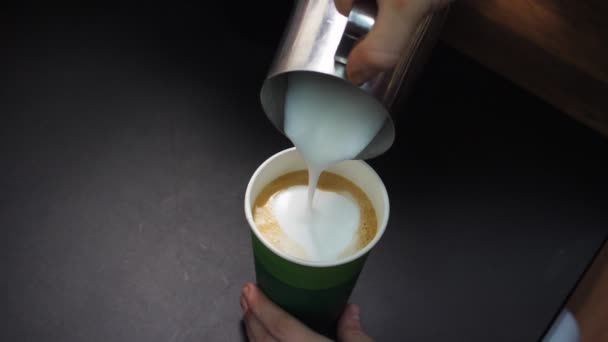 Barista adds whipped milk to delicious coffee at black table — Stock Video