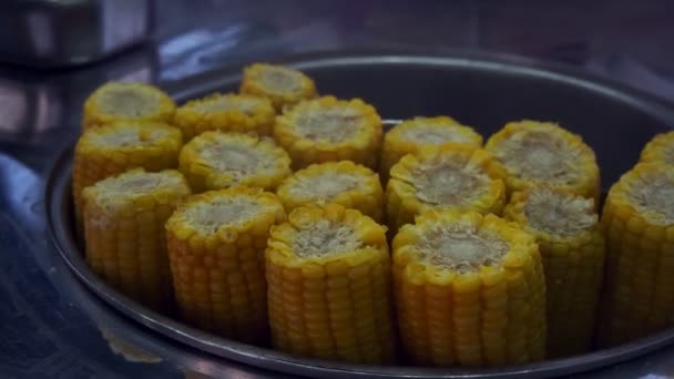 Person puts stick into boiled corn cob in pot in cafe — Stock Footage Person puts stick into boiled corn cob in pot in cafe Stock Footage