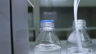 Atölyede plastik çubuğu sıvı ile şişeye koymak