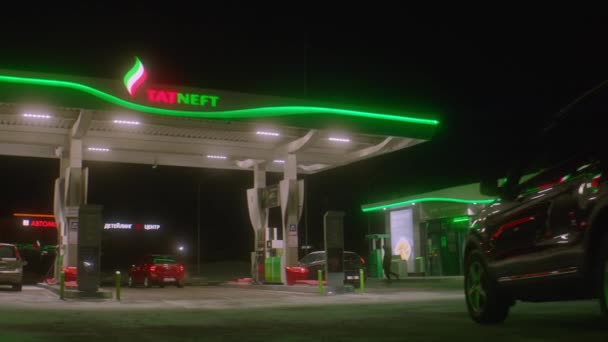 Conducciones de automóviles a la estación de gasolina iluminada Tatneft — Vídeo de stock
