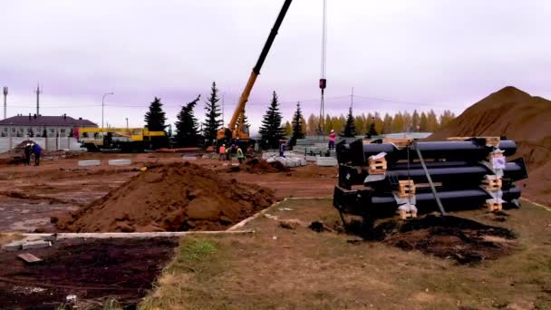 Jeřáb přepravuje velký betonový blok na staveništi — Stock video