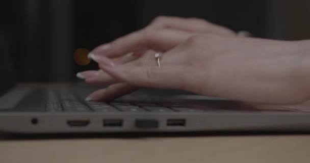 Frauenhände mit Maniküre auf Laptop-Tastatur am Tisch — Stockvideo