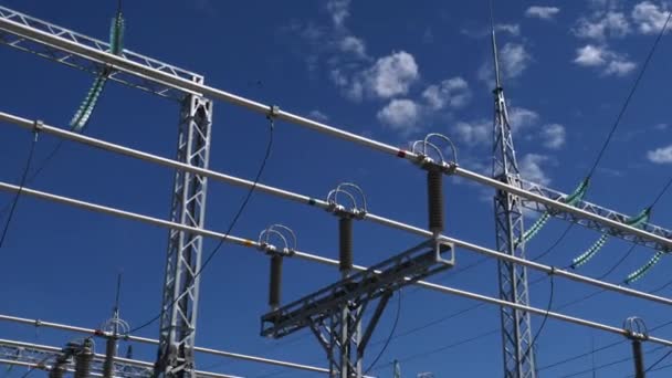 Stroomleidingen met steunen en isolatoren tegen blauwe lucht — Stockvideo