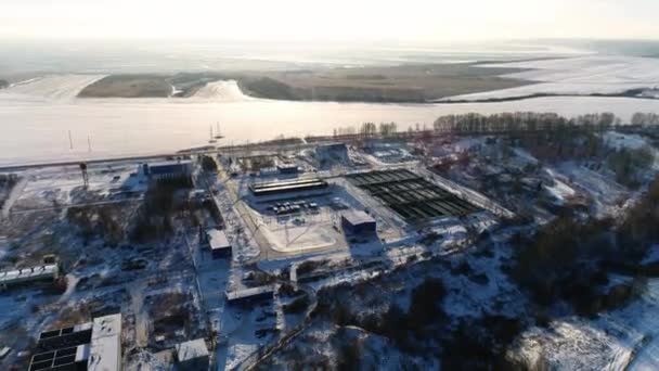 Wastewater treatment plant near field covered with snow — 图库视频影像