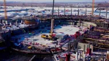Vinçleri ve çalışanları olan spor stadyumu inşaatı