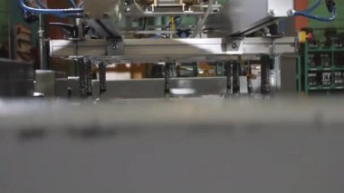 Manipulator with vacuum cups carries metal sheet in workshop