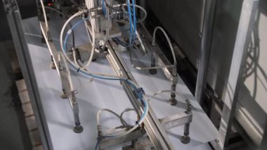 Manipulator takes and transports white sheet at plant