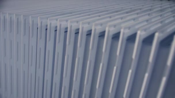 Motion past stack of plastic parts of refrigerator doors — Stock Video