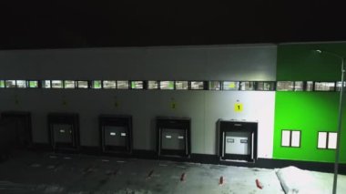 Kış gecesi kapalı rampa kapıları olan depo binası.