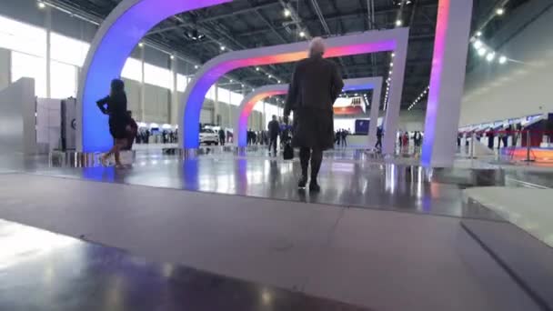 Les gens marchent sous les arches avec conduit soulignant à l'exposition — Video
