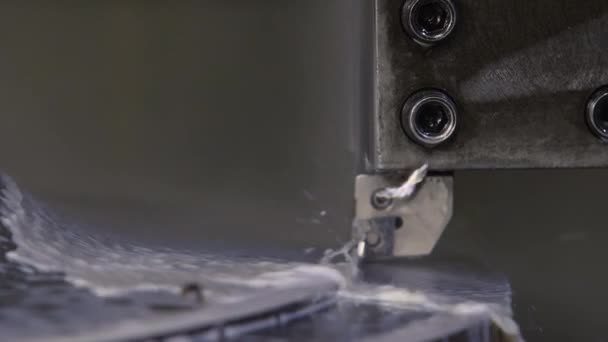 Milling machine cuts edge of turning metal detail with water — Stock Video