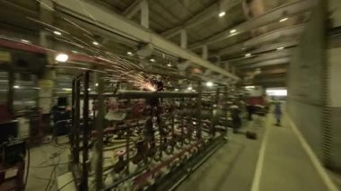 ALMATY, KAZAKHSTAN - 18 Eylül 2025: Atölye karmaşık makineler ve operatörler arasındaki etkileşimi gösteriyor. Sabit hareket, çevresel POV üretiminin yoğunluğunu gösterir.