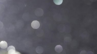 Soyut, aydınlık arka planlı gümüşi bokeh ışıkları. Şenlikli dekorasyonlar 