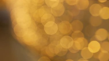 Golden and red warm bokeh lights on a dark background softly blurred circles of light festive cozy atmosphere