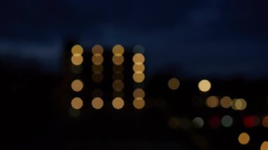 An abstract background with blurred car headlights at night and a soft bokeh effect is perfect for automotive, transportation, and urban design project